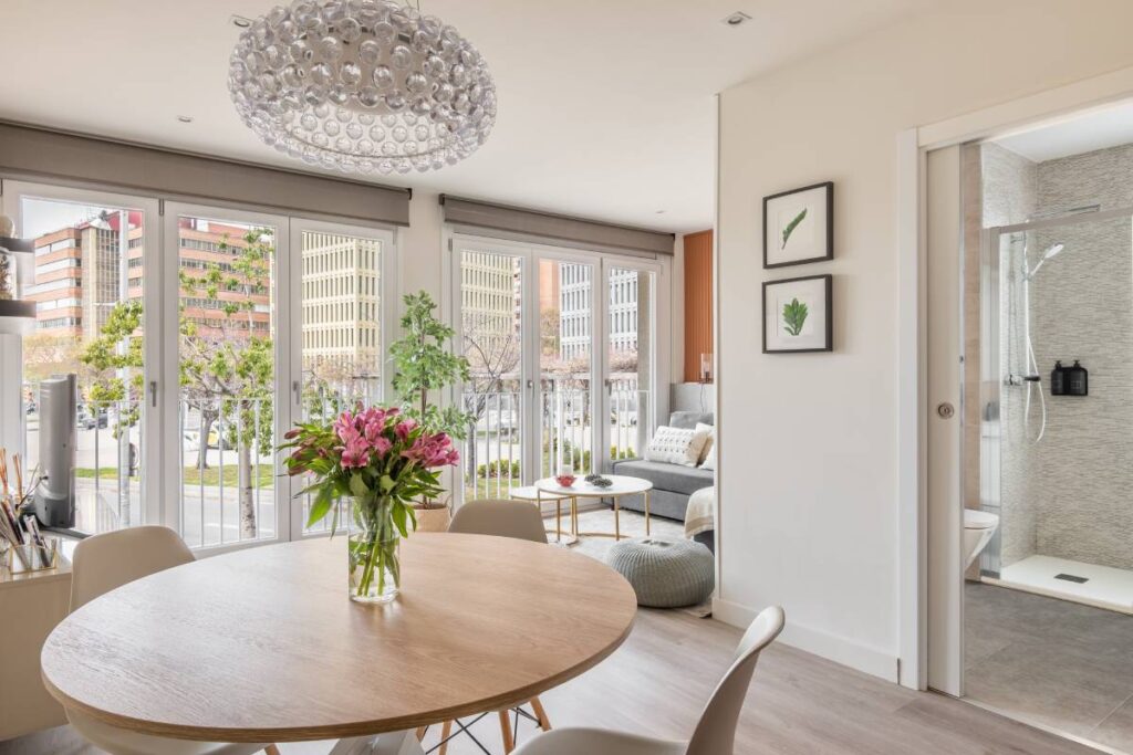 Custom Roman shades pulled all the way up on windows in a bright and chic interior