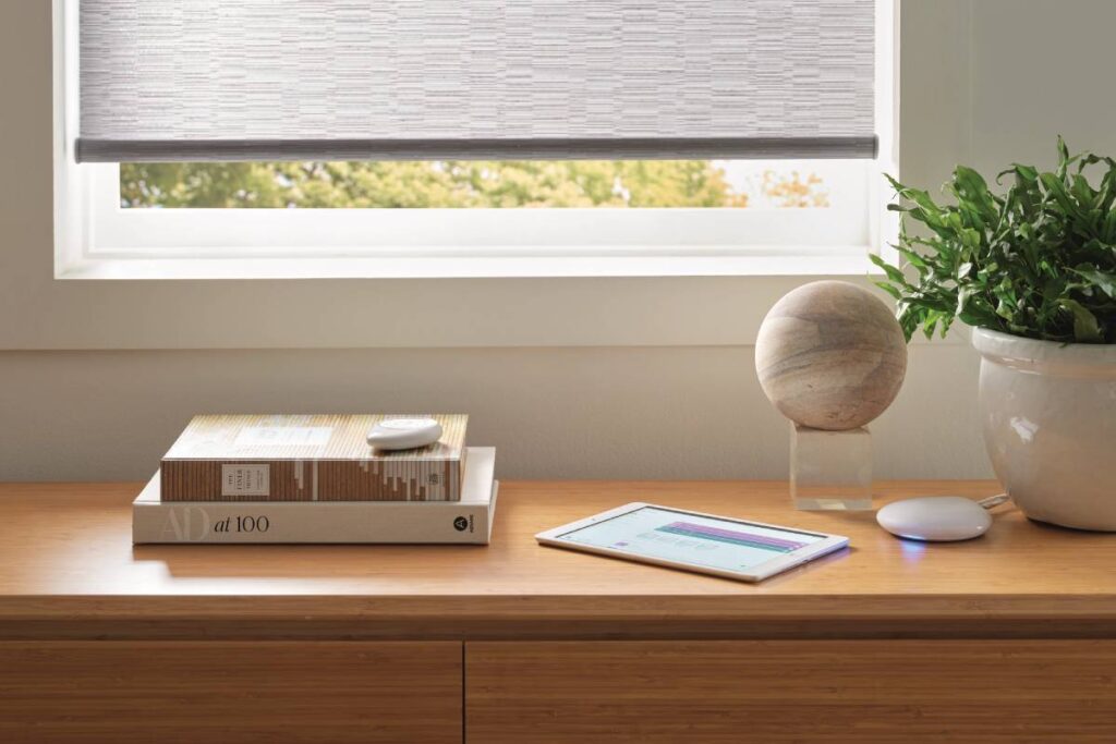 Gadgets for the Hunter Douglas PowerView® Automation, including a tablet with the app and Gateway system