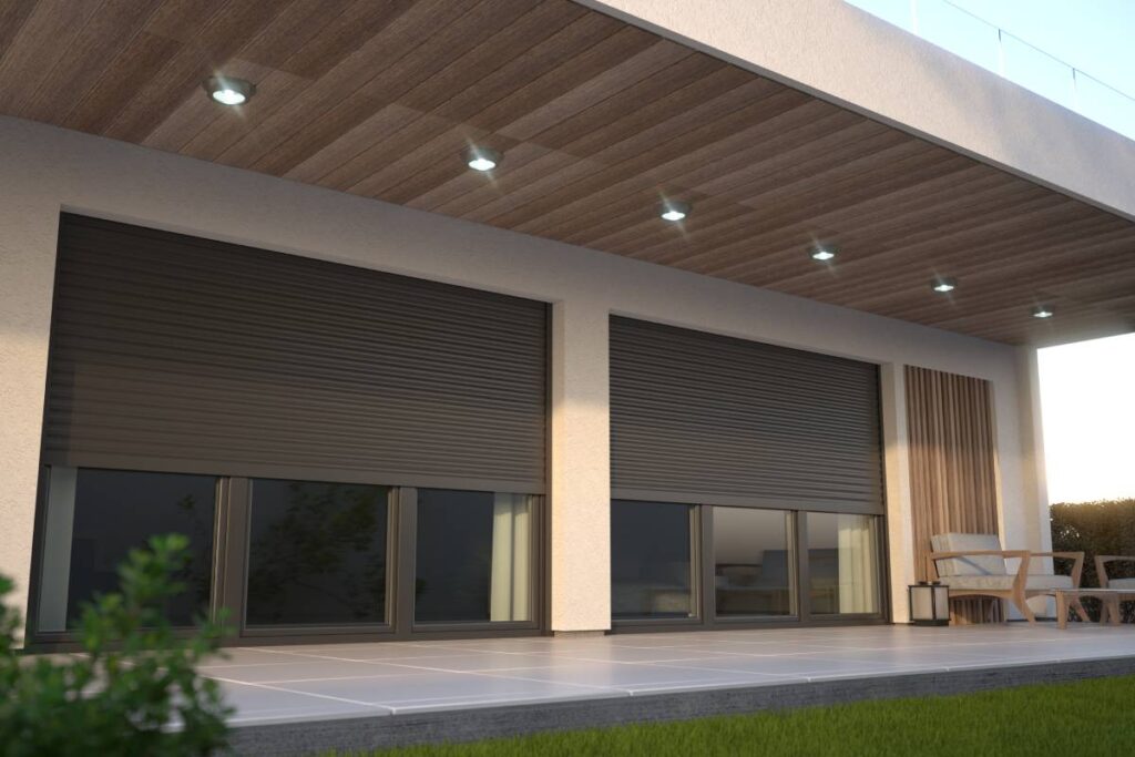 Sleek and modern exterior roller shades on the outside of a home, covering expansive windows