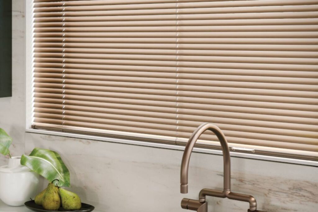 Hunter Douglas Modern Precious Metals® Mini Blinds on a window above a kitchen sink