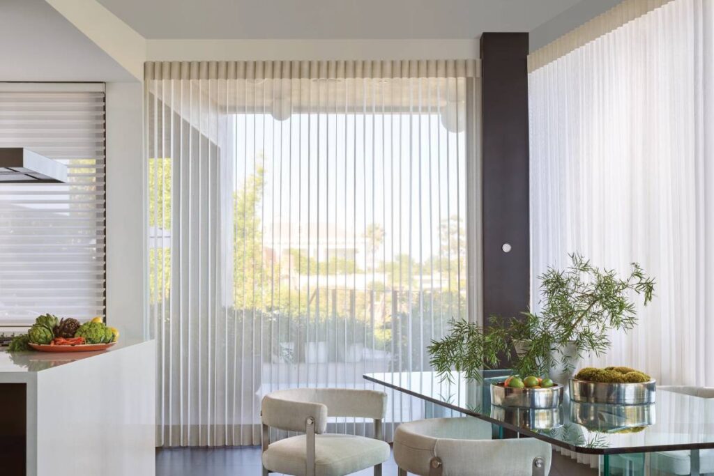 Hunter Douglas vertical blinds with the PowerView® Gateway on the wall of a sleek kitchen