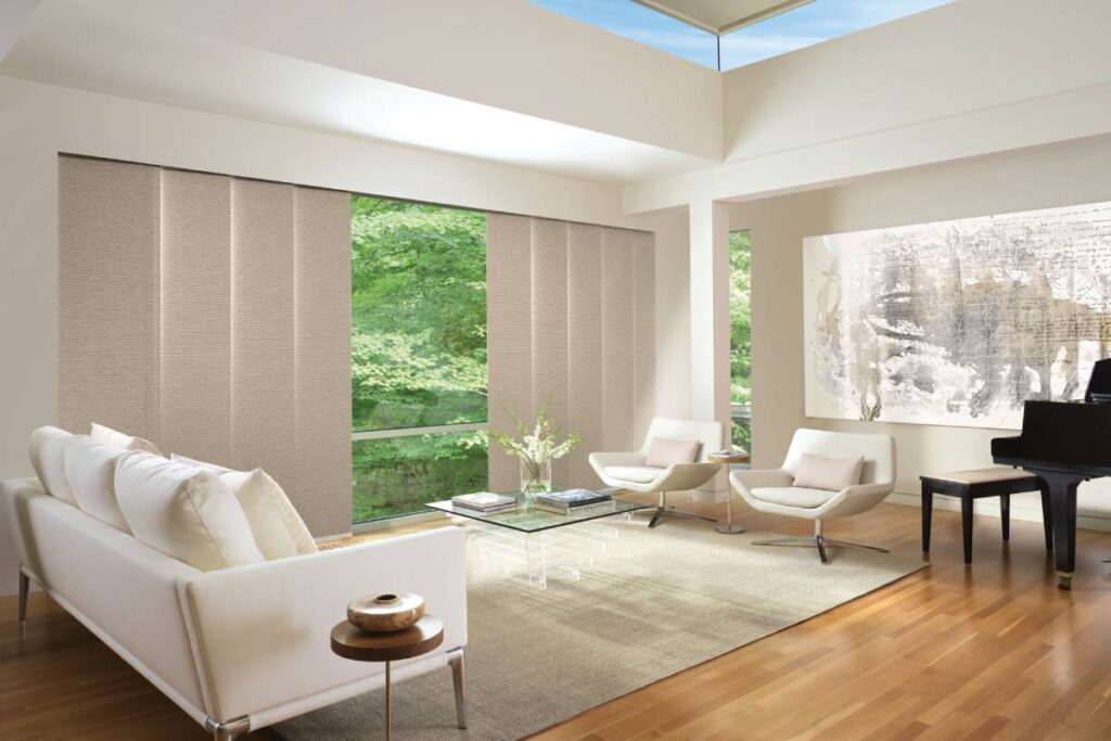 Open Hunter Douglas Skyline® Panel-Track Blinds on expansive glass in a chic living room