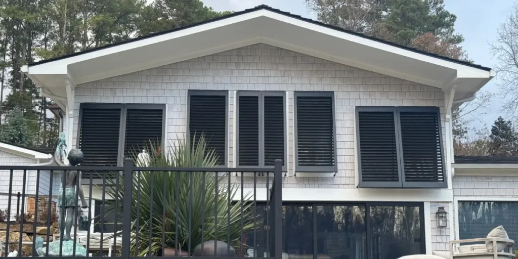 Bahama Shutters on windows of a home's exterior, installed by Metro Shutters & Blinds near Marietta, GA
