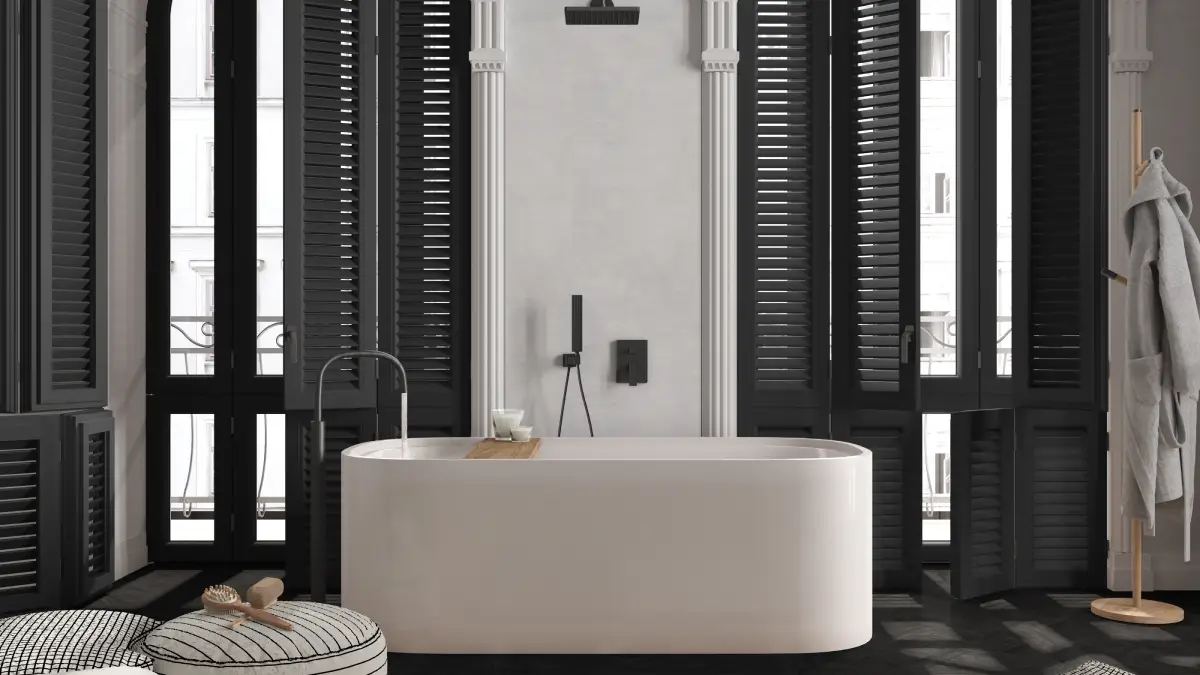 Custom black shutters in a bi-fold style on large, tall windows in a chic bathroom
