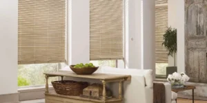 Hunter Douglas Parkland® Wood Blinds on large living room windows that warm the space