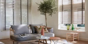 Hunter Douglas horizontal window blinds with decorative tapes on windows in a home's great room