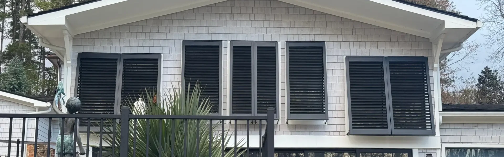 Bahama Shutters on windows of a home's exterior, installed by Metro Shutters & Blinds near Marietta, GA