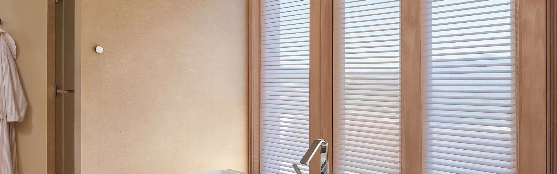 Hunter Douglas PowerView® Automation system on the wall next to dark blue Designer Banded Shades